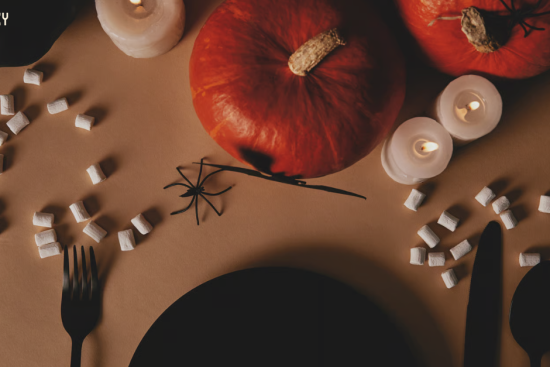 Halloween music for businesses: a restaurant table set with pumpkins, candles, black plates and cutlery for an October dinner Halloween music for businesses 2026 article · DOCX