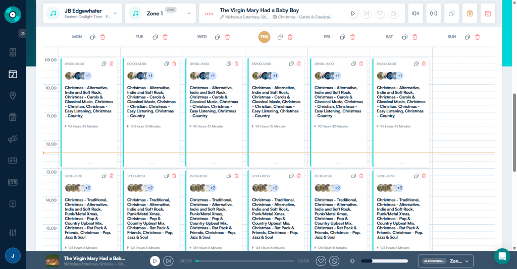 Weekly schedule view in the Jukeboxy music manager, with Christmas playlists (traditional, pop, classical, jazz and soul, country and easy listening mixes) scheduled by day and time for a business location. Shows how to plan holiday music in advance and switch it on and off automatically for the season.